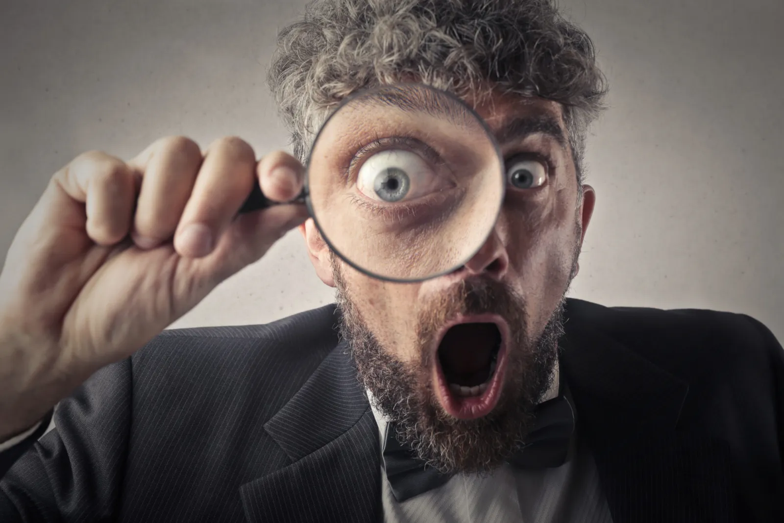 Photo Of Man Holding Magnifying Glass Close To His Eye